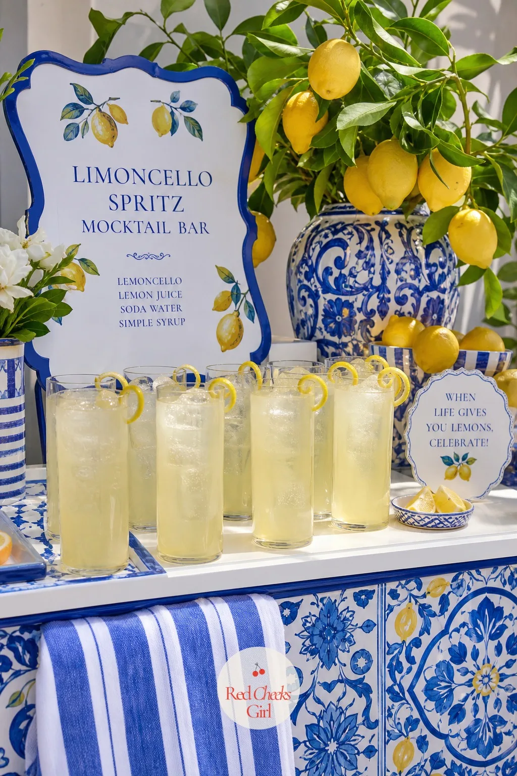 A Limoncello Spritz Mocktail Bar — Tall glasses filled with ice carry a pale yellow spritz poured over the top, a lemon twist curled on the rim of each one as