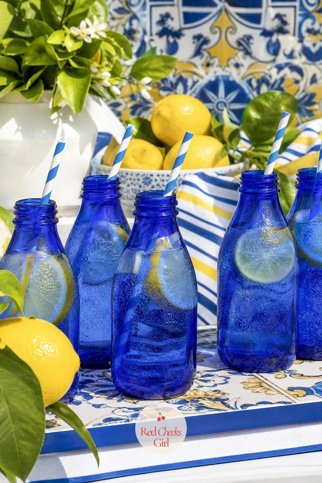 Sparkling Citrus Water in Blue Glass Bottles — A row of cobalt glass bottles filled with sparkling water looks finished before anyone even touches one. Amalfi