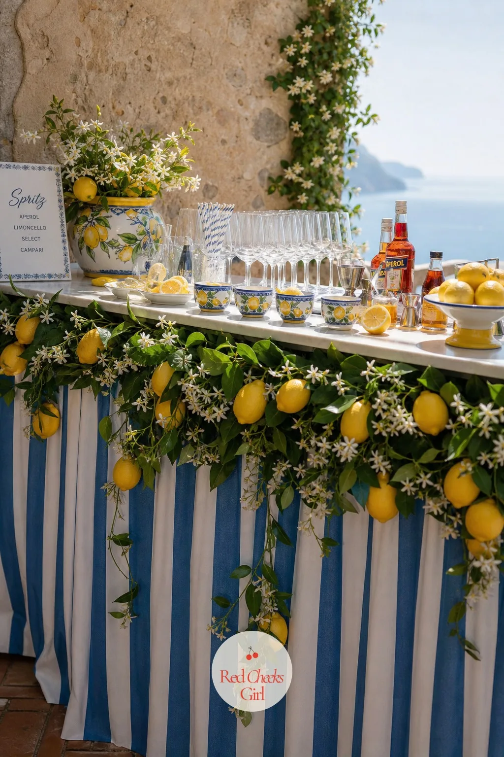 The Lemon Garland Over The Bar — A bar table alone, without anything above it, disappears against a busy terrace. Amalfi coast wedding