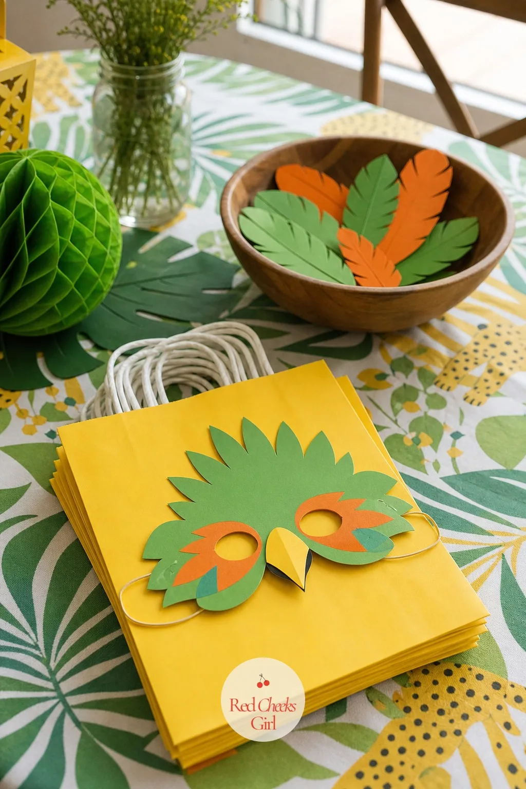 Parrot Mask Headband Favor — Green and orange paper cut into rough feather shapes and layered onto an elastic headband gives this favour more texture than a
