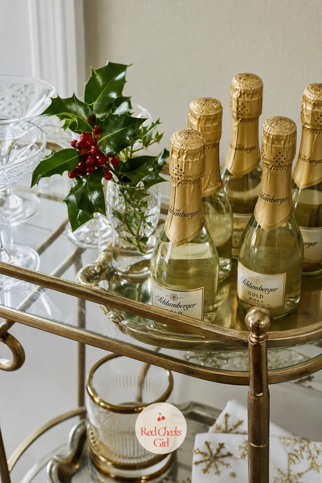 A Bar Cart Dressed for the Season With Mini Bottles and Holly — A bar cart on wheels is an apartment's best Christmas prop, since it rolls wherever the party