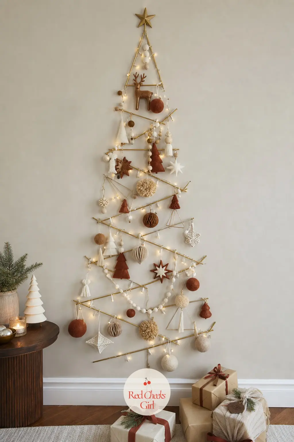 A Flat Brass Rod Tree Mounted to the Wall — A geometric metal frame shaped like a slim pine silhouette hangs flush against the wall and holds real ornament