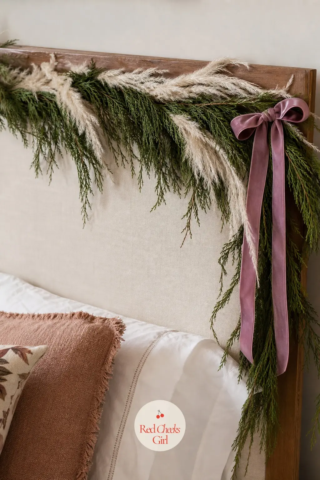 A Headboard Framed With Cedar and Pampas Plumes — One slim garland along the top of a headboard is enough to make a bedroom feel seasonal without competing