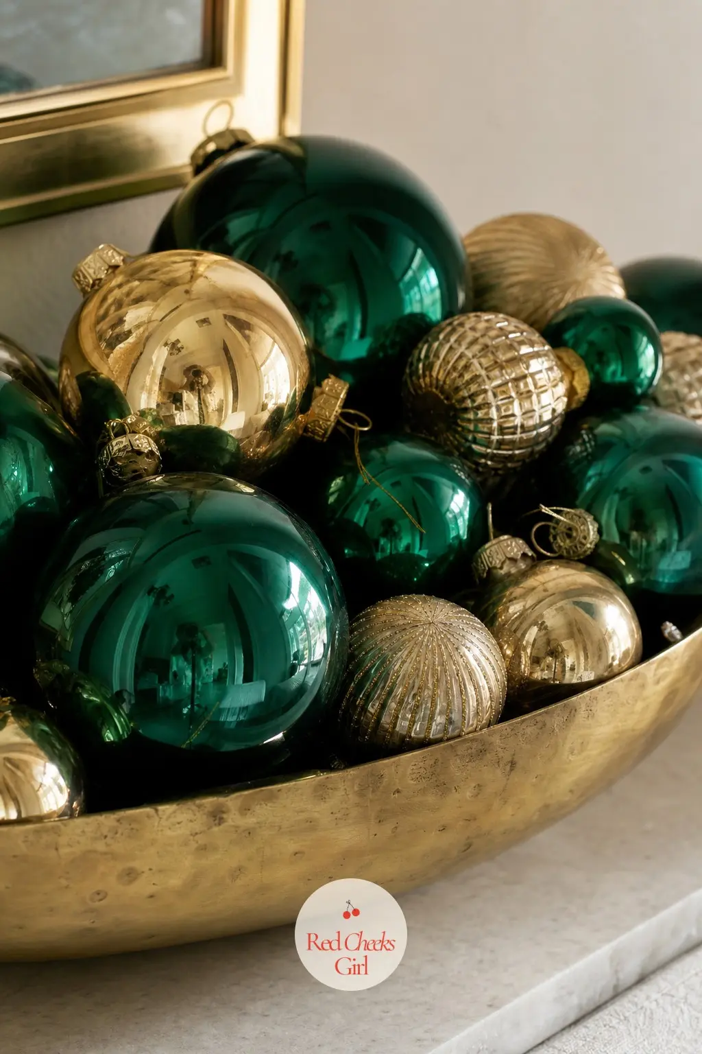 A Shallow Brass Bowl Filled With Emerald and Gold Ornaments — One bowl on a narrow entry shelf does the job a whole console usually does. Apartment christmas