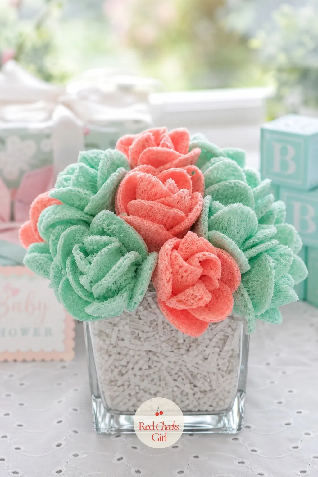 Bath Sponge Flowers — A baby bath sponge, trimmed at the edges into rounded petal shapes, dries into something closer to a peony than a bath tool. Baby shower