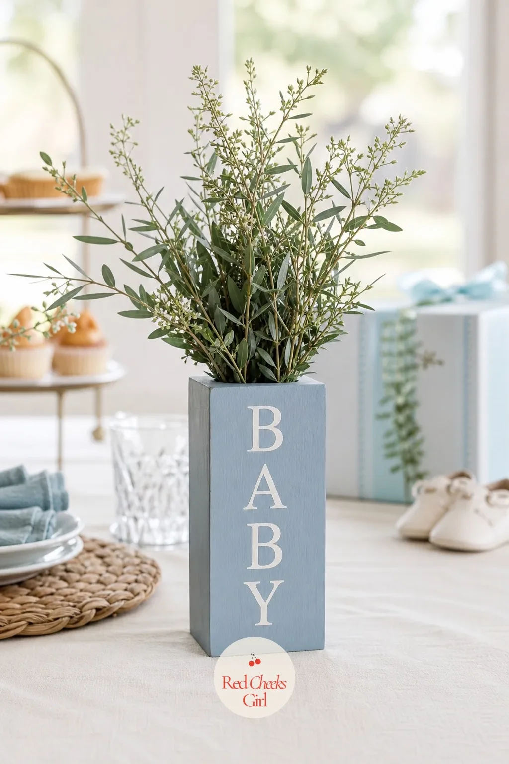 Block Vase Sleeve — A wooden block painted dusty blue, drilled through the center to fit a slim glass vase insert, looks like a single solid object rather than