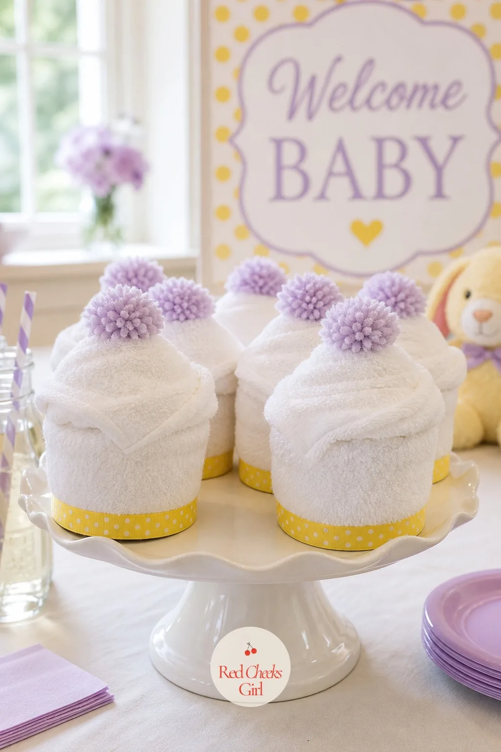Hooded Towel Cupcakes — A white terry hooded towel rolled tight and stood on end, hood folded over the top like frosting, looks enough like a cupcake to fool a