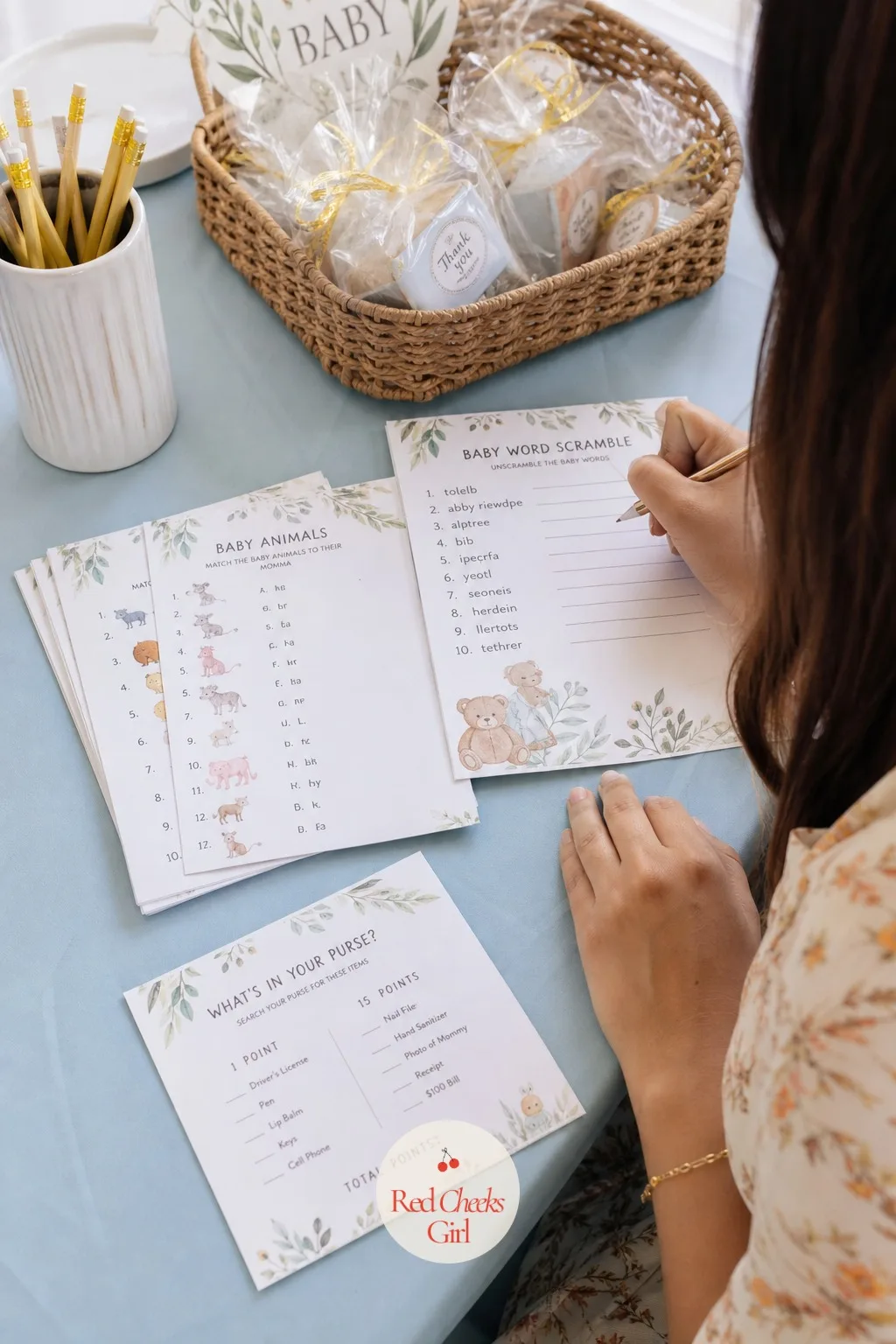 Pick Two or Three Games, Never More — A small table holds game cards fanned out beside a pencil cup and a basket of small prizes, set up and ready before