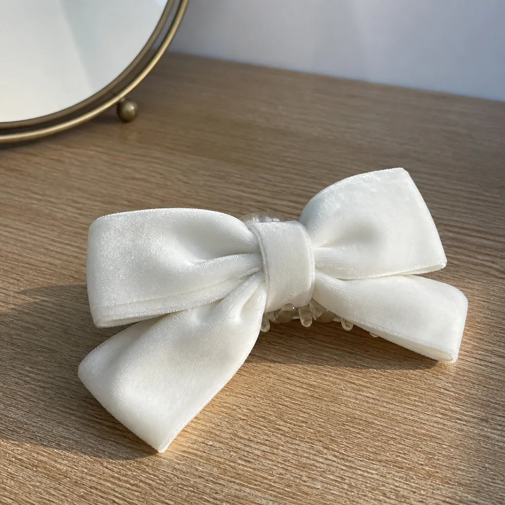 Bride Hair Bow — A bow clipped into a low ponytail reads as 'bride' from across the room, no sash required. Bachelorette gifts for the bride