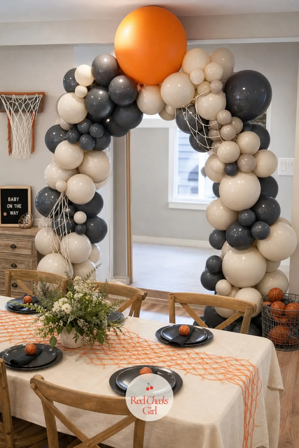 Charcoal and Cream Balloon Arch with a Single Orange Sphere — A balloon arch covers a lot of visual ground for very little money, and one oversized orange