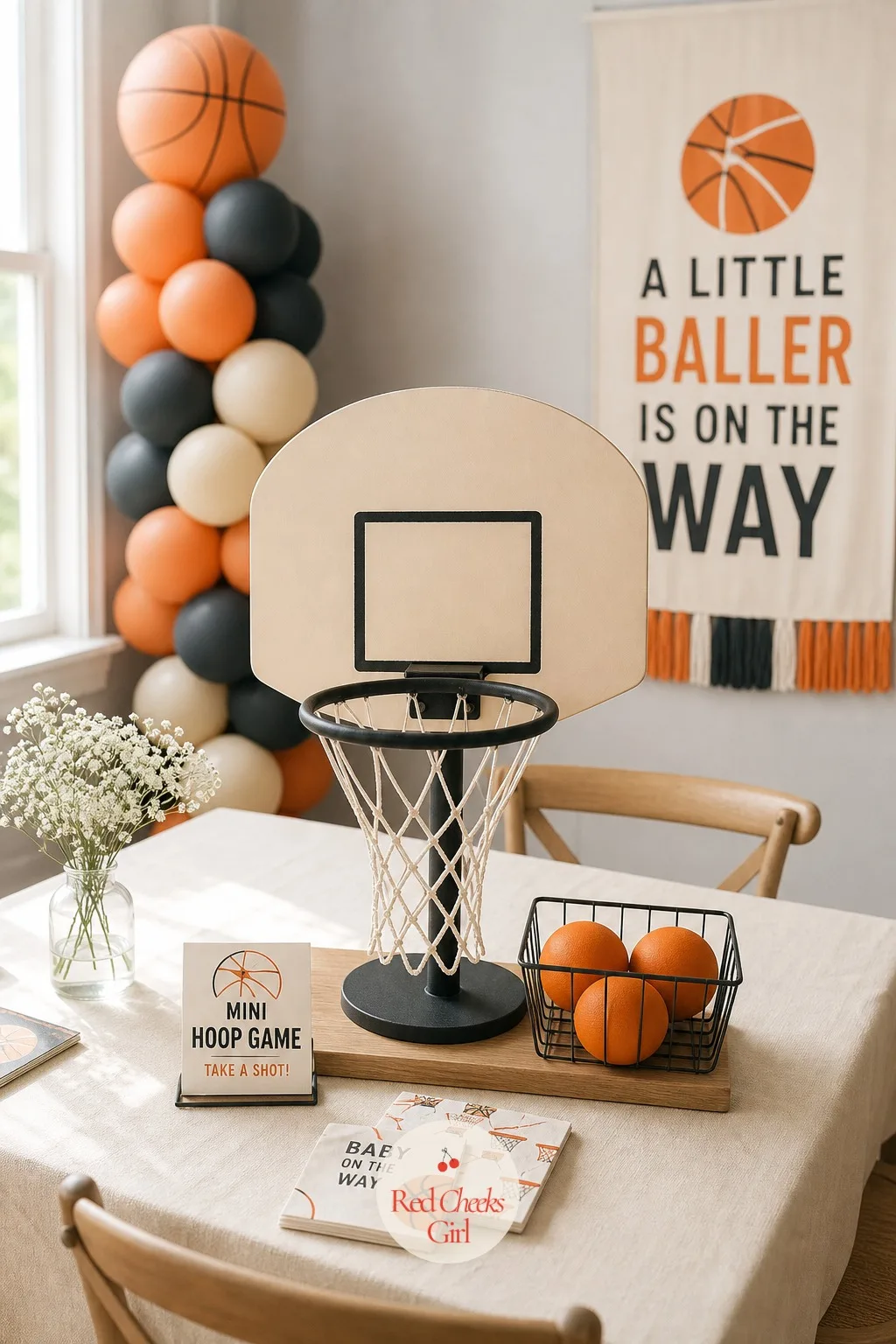 Mini Hoop Game Table — A freestanding mini hoop stand with a backboard and a real net sits on a low table or cart, close enough to the entrance that it is the