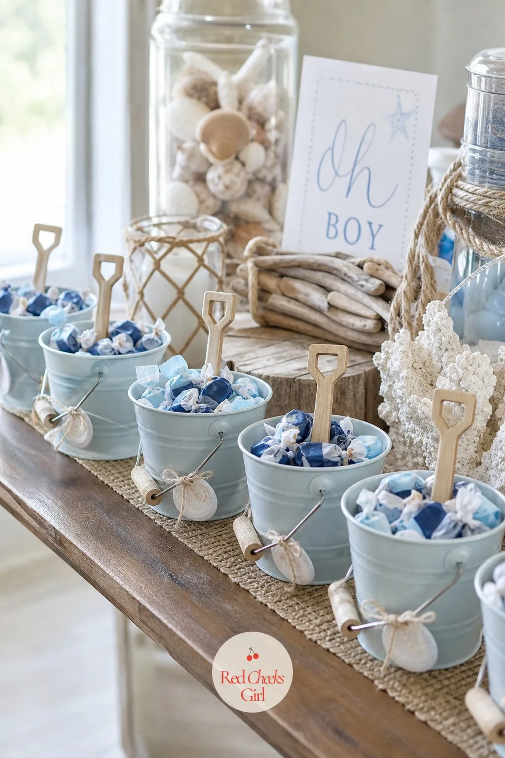 Mini Sand Pail Treat Favors — Small metal pails, the kind sized for a child's hand rather than an adult's, get filled with a scoop of blue and white wrapped