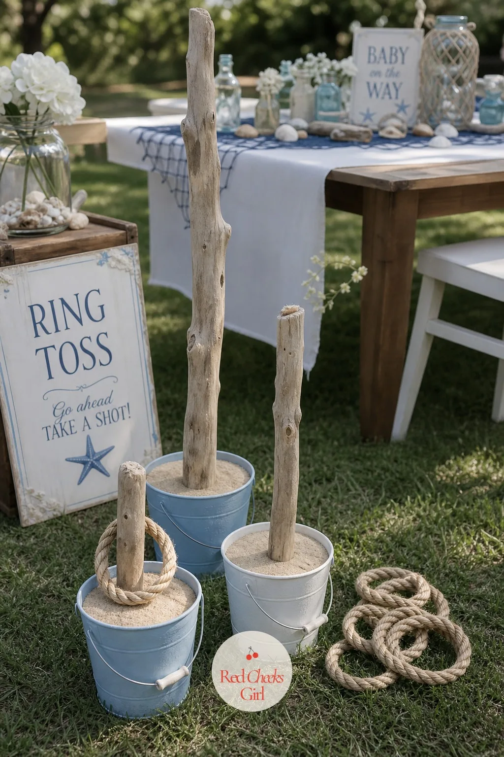 Ring Toss onto Driftwood Posts — Several driftwood branches, cut to different short heights, stand upright in small buckets filled with sand to hold them