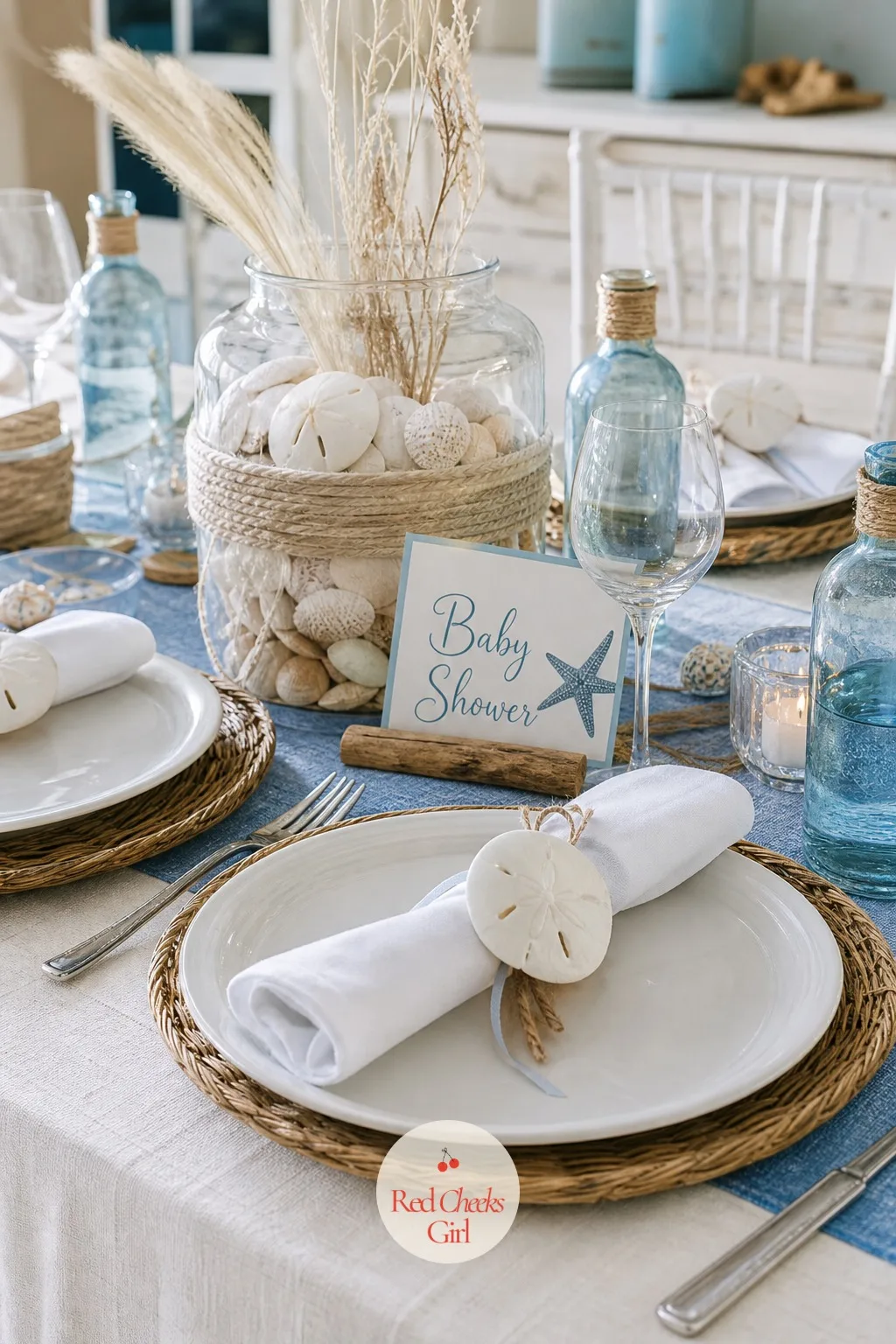 Sand Dollar Napkin Rings — This small detail turns a plain folded napkin into part of the theme without adding a single extra object to the table. Beach theme
