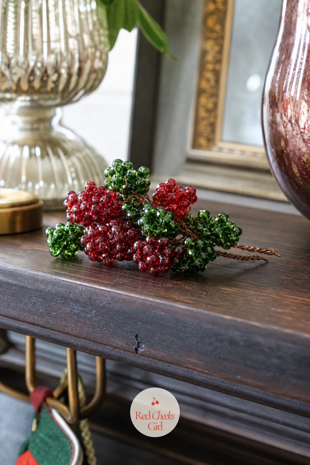 Stacked Berry Cluster — This one skips snowflakes and stars entirely and goes for a cluster of beaded berries instead, cranberry red stacked against holly