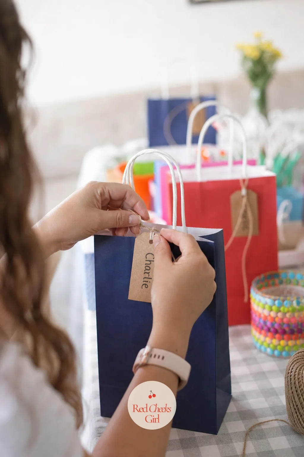 A Handwritten Name Tag Tied To The Bag — The very last touch, and the cheapest one on this whole list, costs a strip of card and two minutes with a marker.
