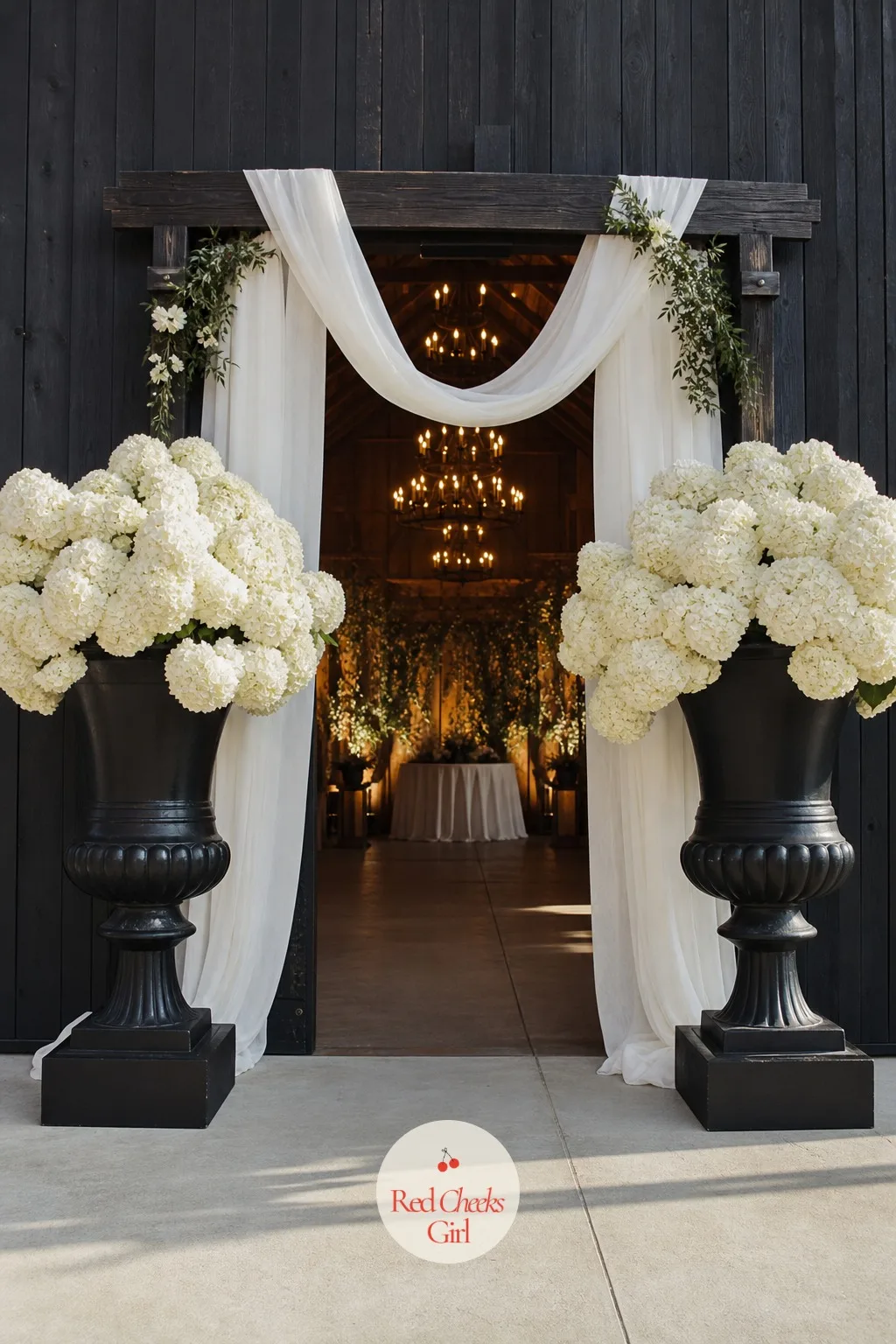 Black Urns With White Hydrangeas At The Altar — An altar with nothing but a floral arch can look thin from the back row. Black and white wedding decor