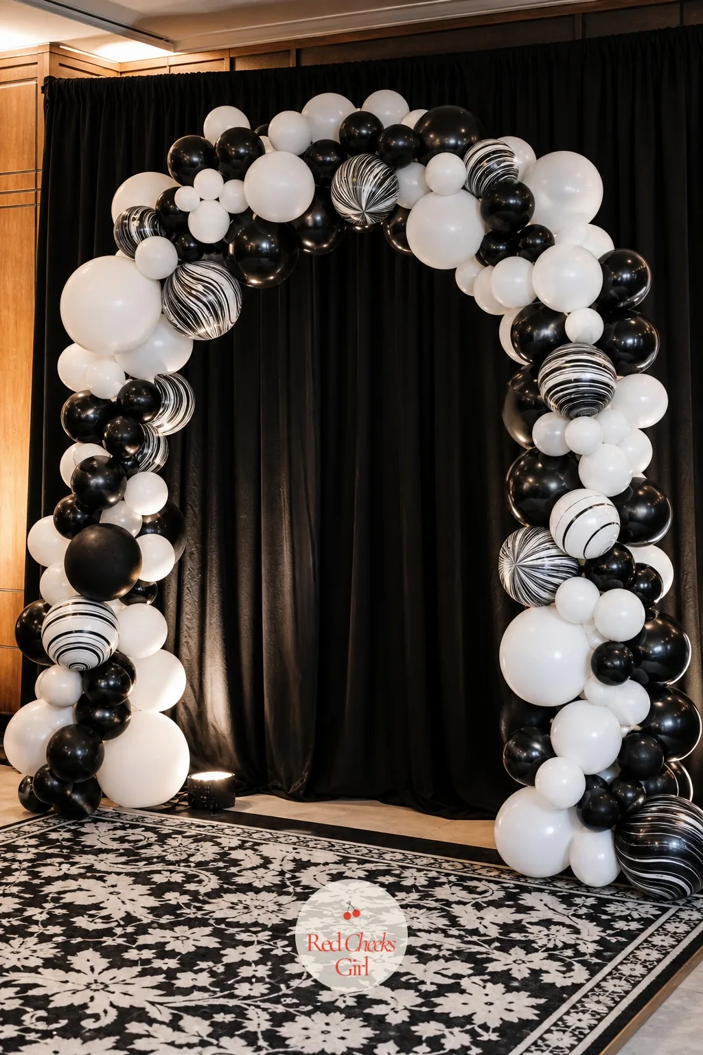 Black and White Balloon Arch Photo Backdrop — A corner left empty between the dance floor and the bar becomes the one spot nobody wants to stand for a