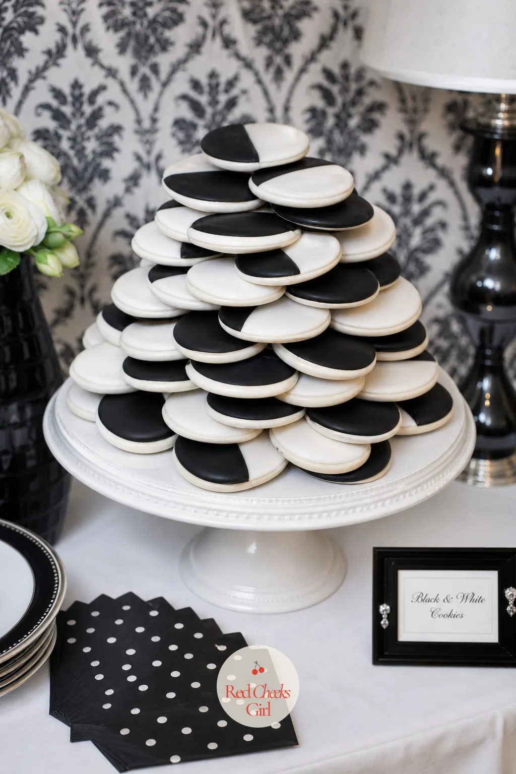 Black and White Cookie Tower — A dessert table needs something guests can grab without a knife, and a tower of iced black and white cookies fills that gap