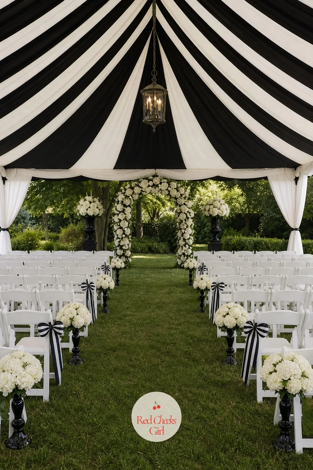 Black and White Striped Tent — A plain white marquee disappears into the lawn behind it, but a tent striped in bold black and white announces the party before