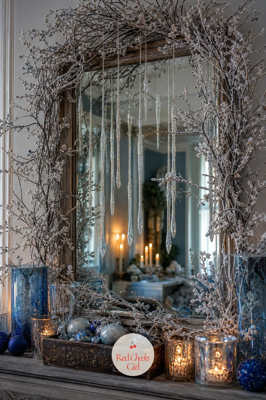 The Foyer Looking Glass, Framed in Frosted Branches — The entry mirror gets ringed in frosted branches with a few hanging glass icicles catching the light from
