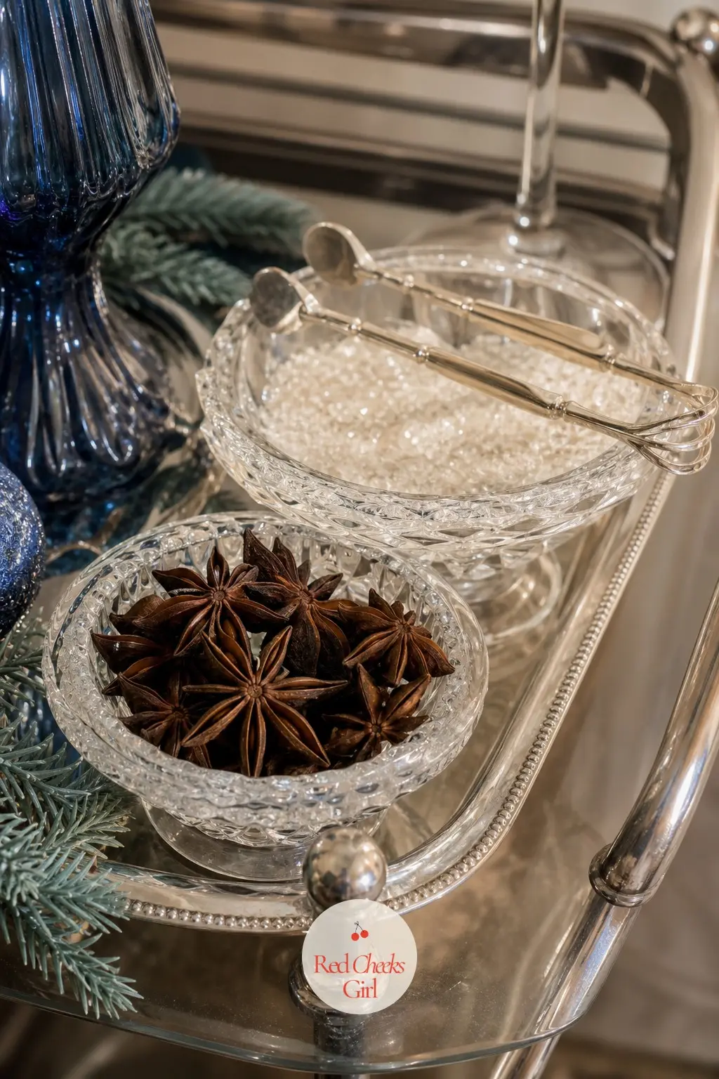 The Garnish Tray, Set With Star Anise and Frosted Sugar Rims — A small tray beside the trolley holds whole star anise, frosted sugar for rimming glasses, and a