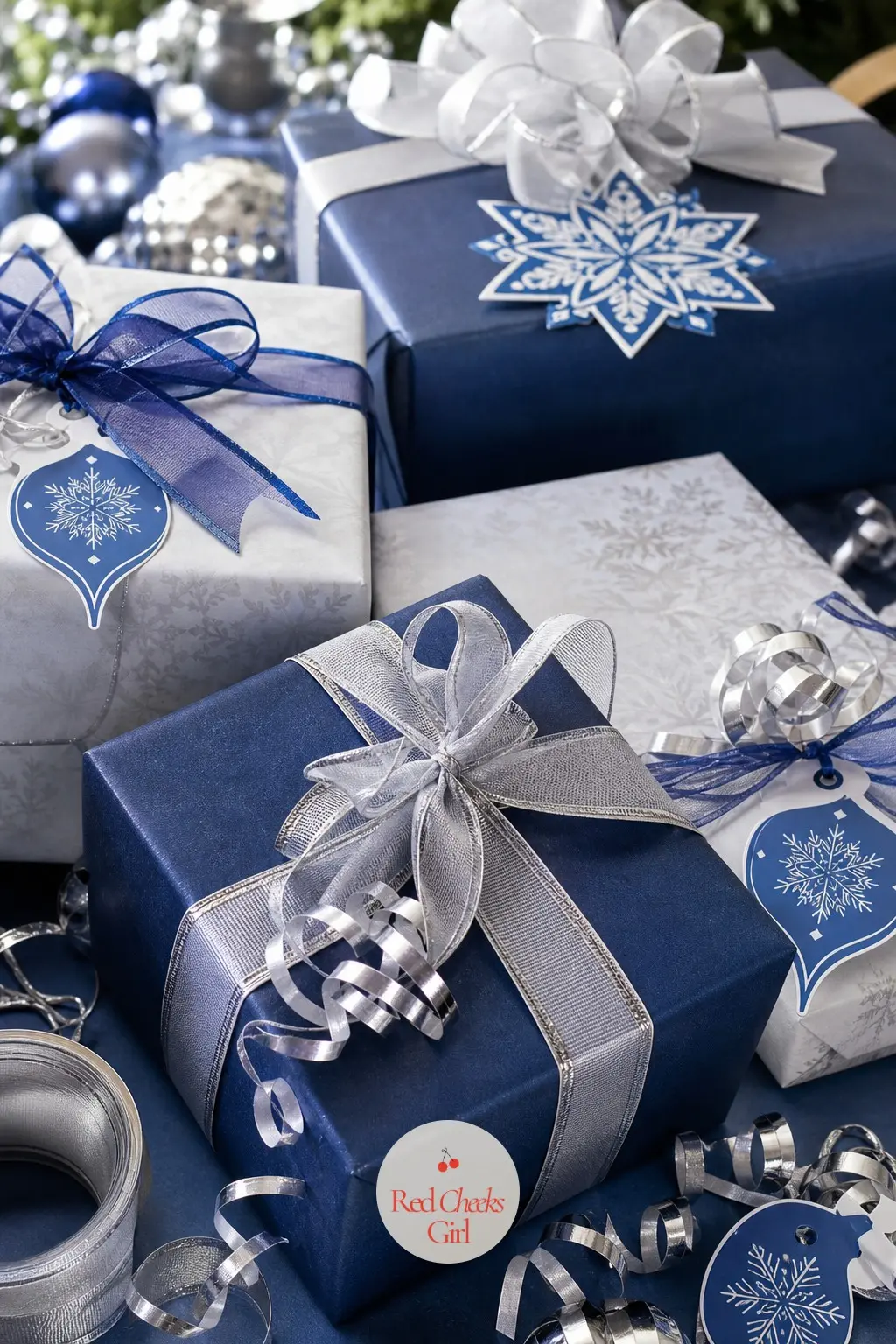 The Gift Wrap Table, Papered in Blue and Silver — Stacked parcels sit wrapped in navy and ice-white paper, silver ribbon curling tightly at each corner, with a