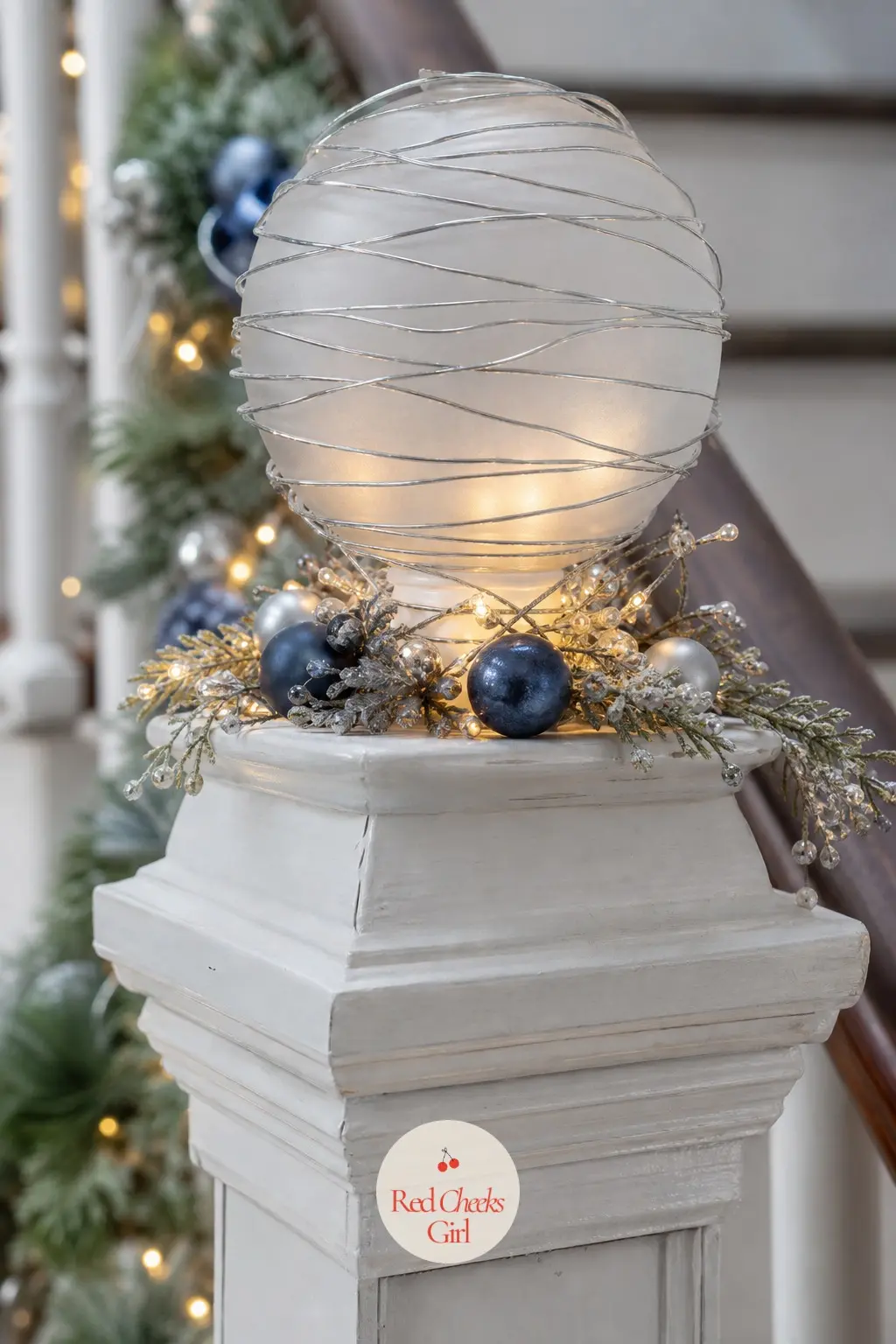 The Newel Post, Topped With a Frosted Glass Finial — The post at the foot of the stairs gets a frosted glass orb finial wrapped in a thin strand of silver