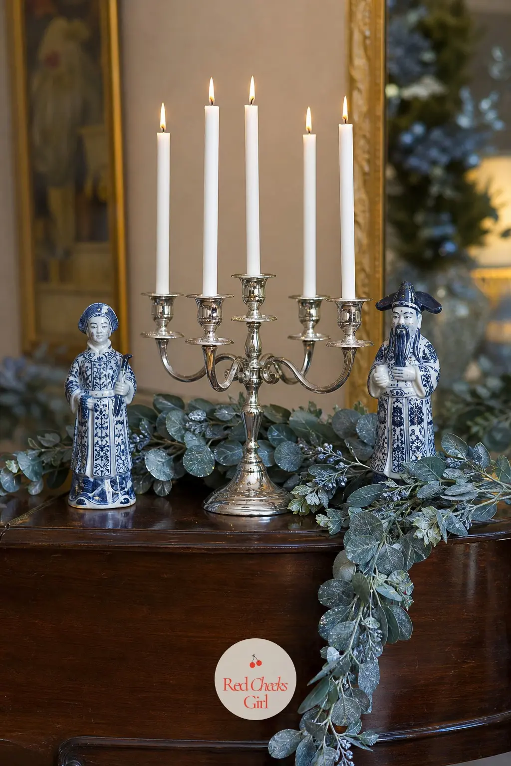 The Piano Top, Styled With Candelabra and Chinoiserie Figures — A silver candelabra sits at the centre of the piano, flanked by two small chinoiserie porcelain