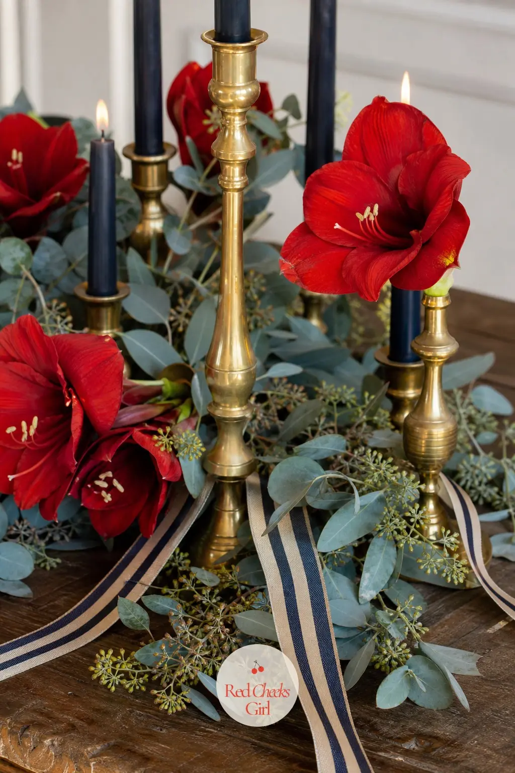 The Centerpiece, Clustered With Brass Candlesticks and Red Amaryllis — A cluster of brass candlesticks at varying heights anchors the centre of the table