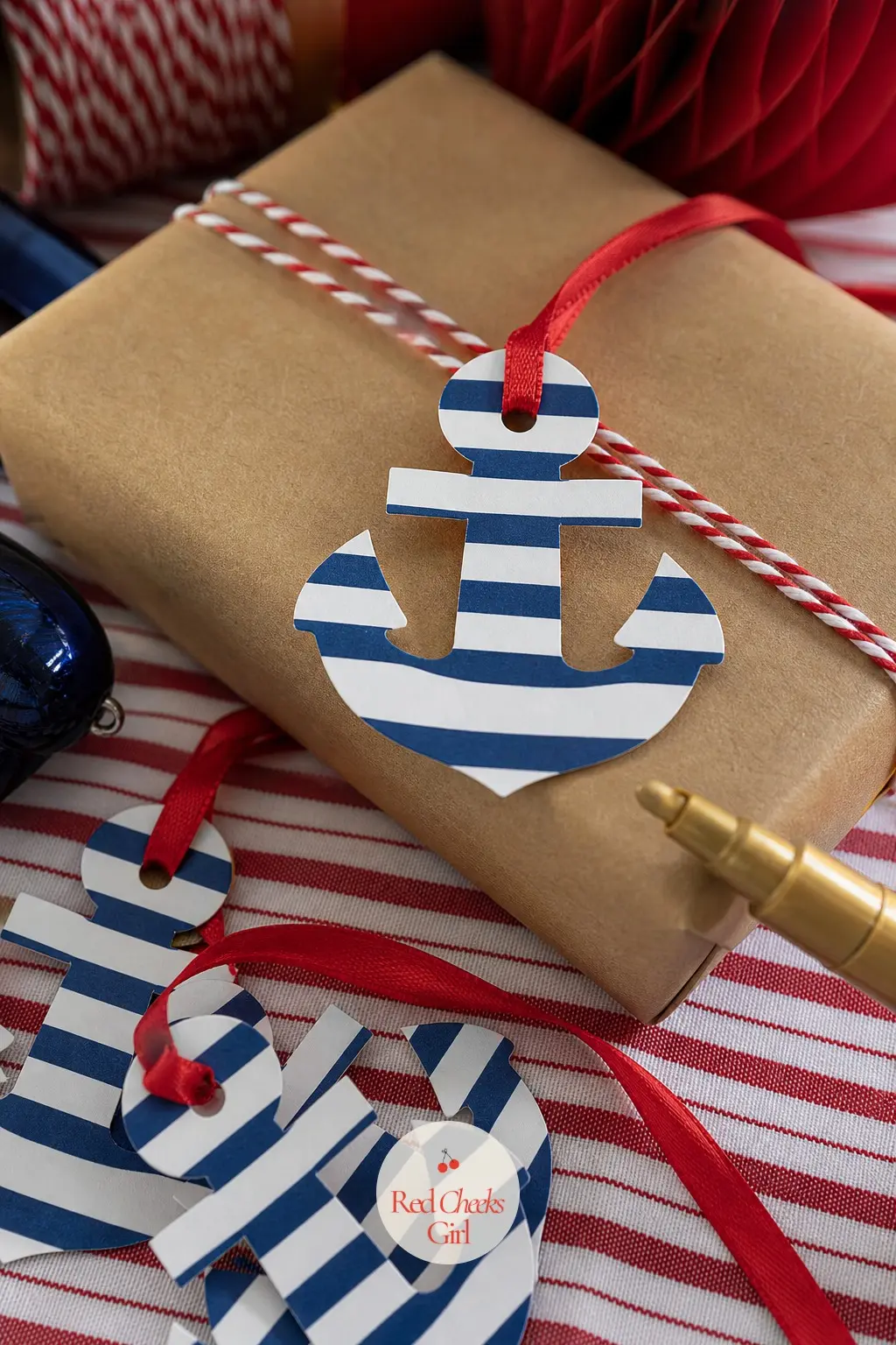The Gift Tags, Cut Into Little Brass Anchors — Leftover scraps of the striped wrapping paper get cut into small anchor shapes with a craft punch, each one