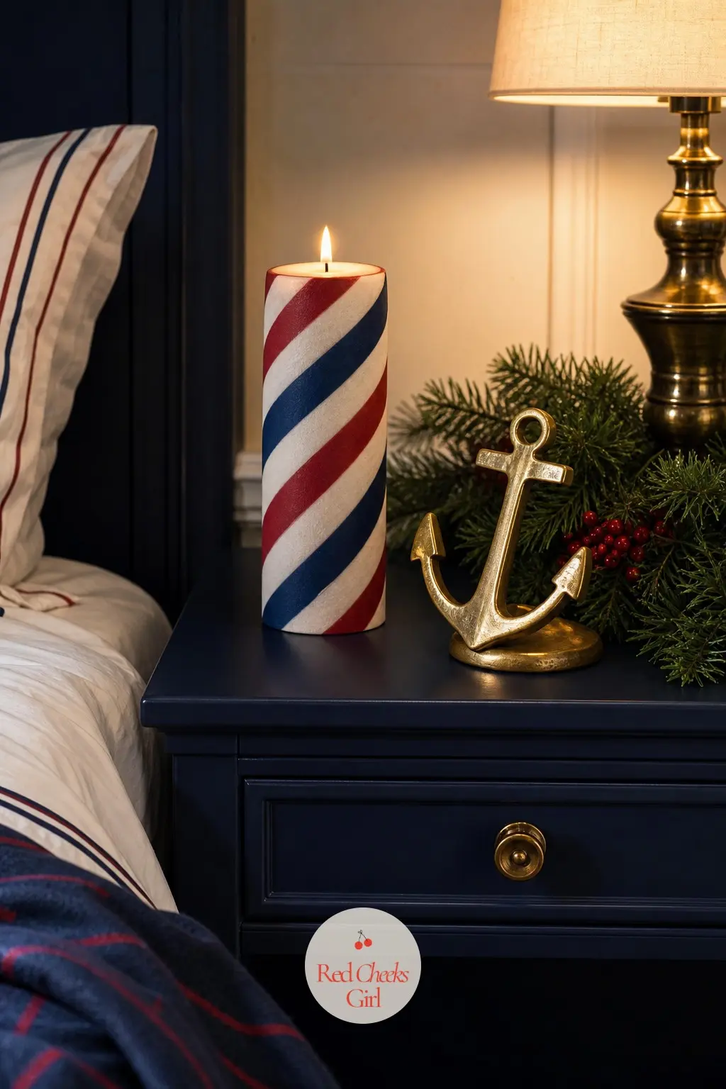 The Nightstand, Set With a Striped Candle and a Brass Anchor — A single striped pillar candle sits on the guest room nightstand next to a small brass anchor