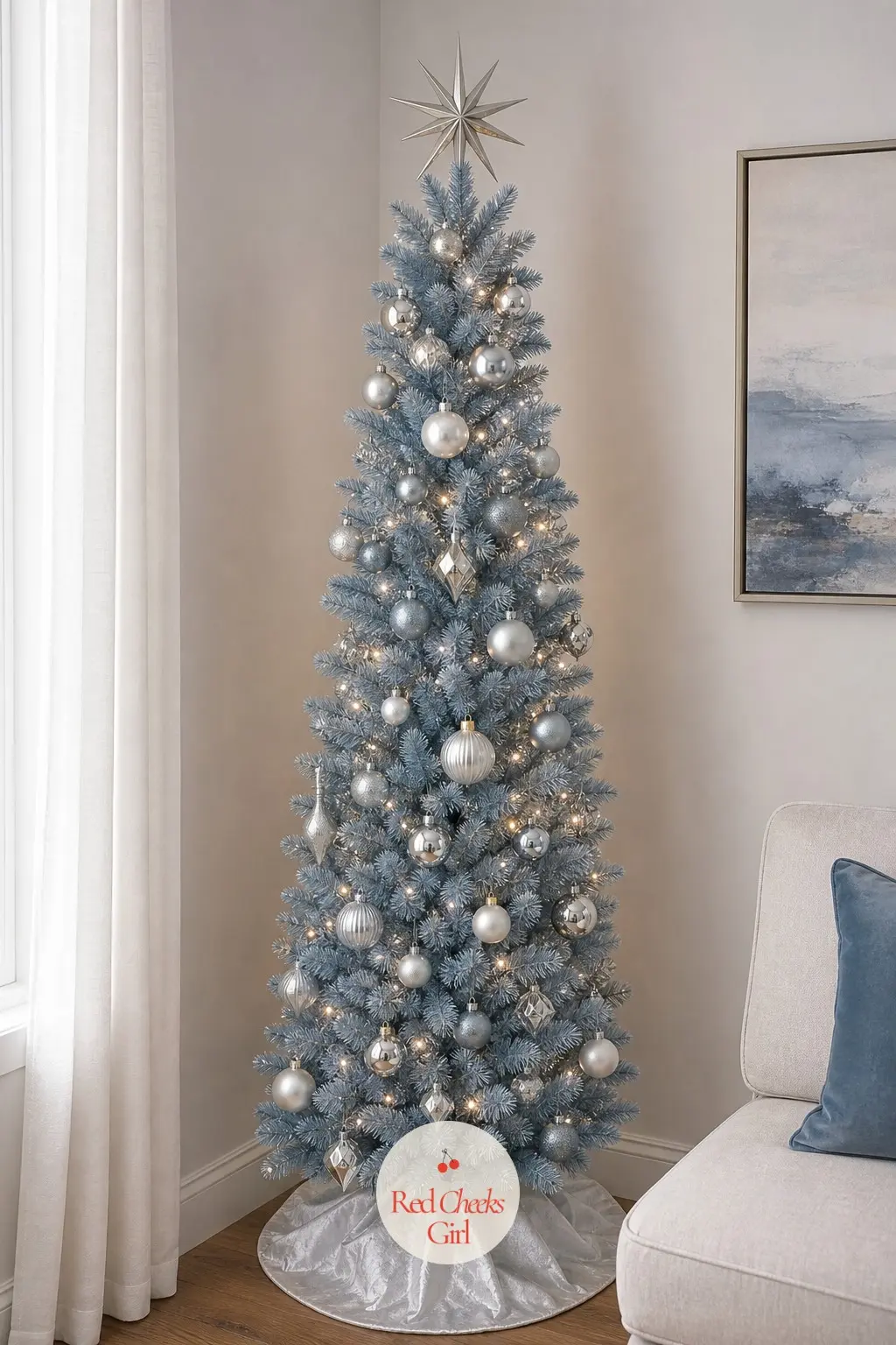 A Dusty Blue Tree Tucked Into One Corner — A slim artificial tree pushed into the one free corner of a small flat's main room, dusty blue paired with soft