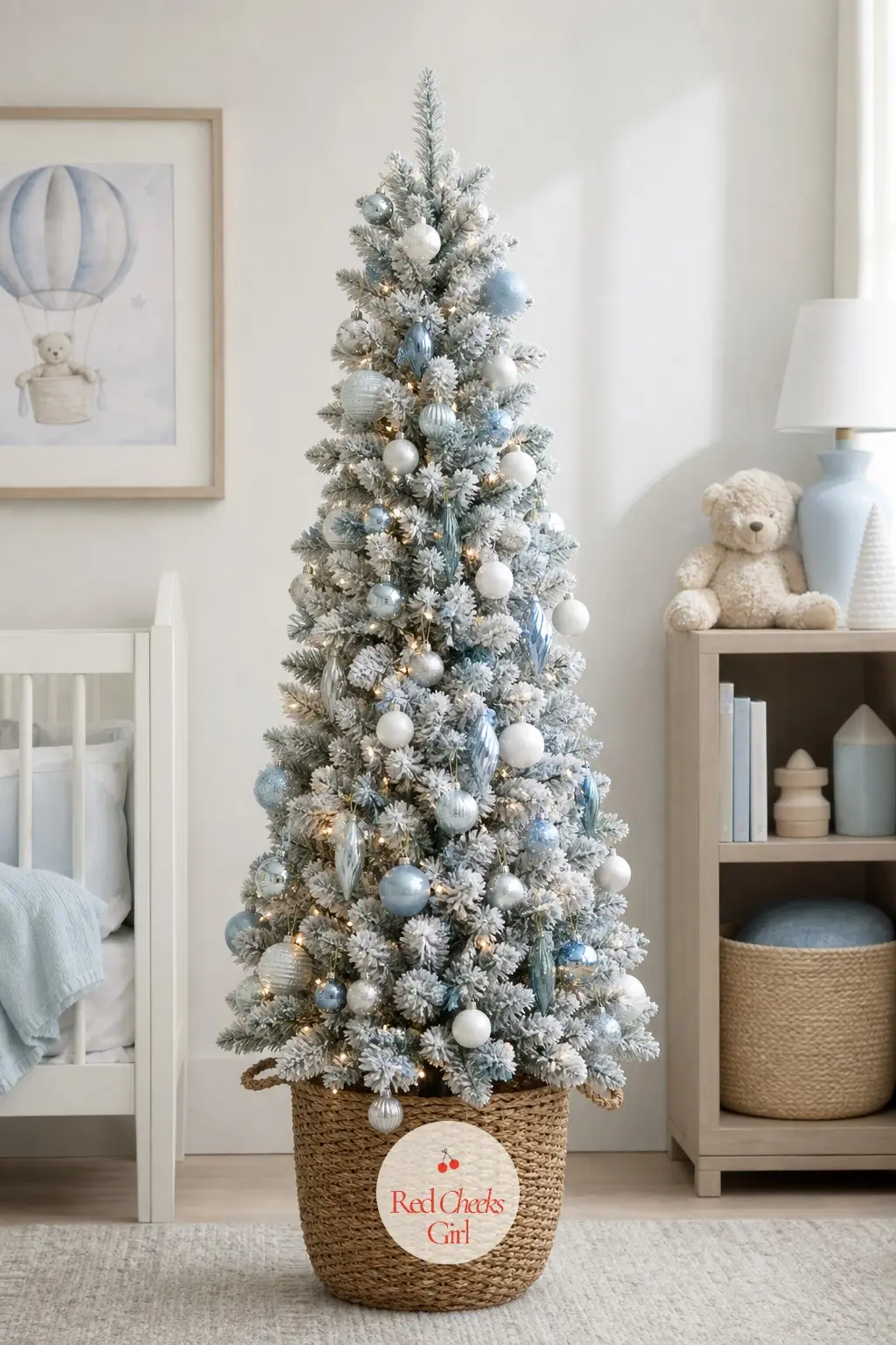 A Frosted Tabletop Tree for the Nursery Shelf — A small flocked tree in a woven basket, sitting at a height a toddler can actually see without climbing onto