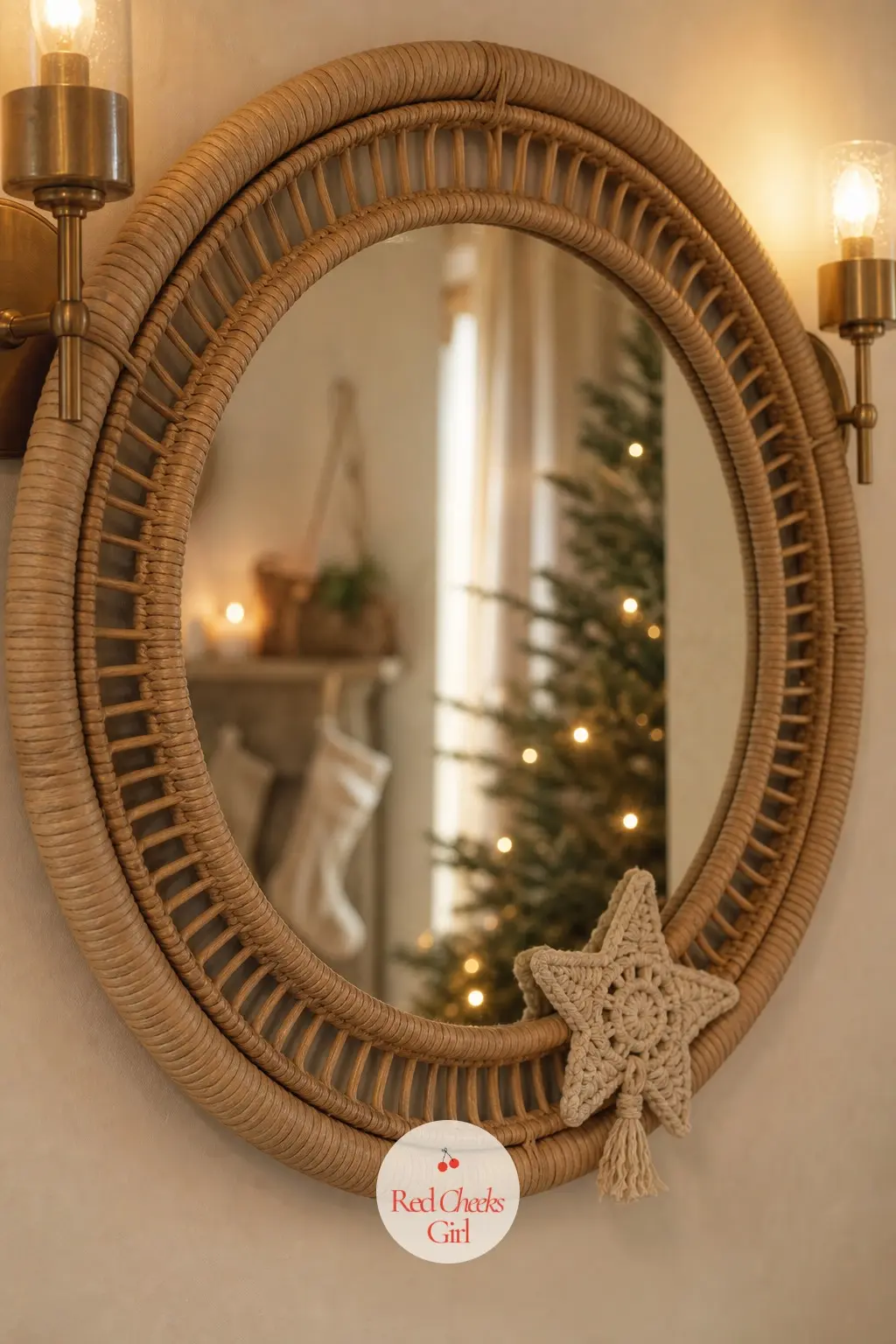 The Hallway Mirror — A round rattan-framed mirror hangs between two brass sconces, a small macrame star tucked into the lower corner of the frame rather than