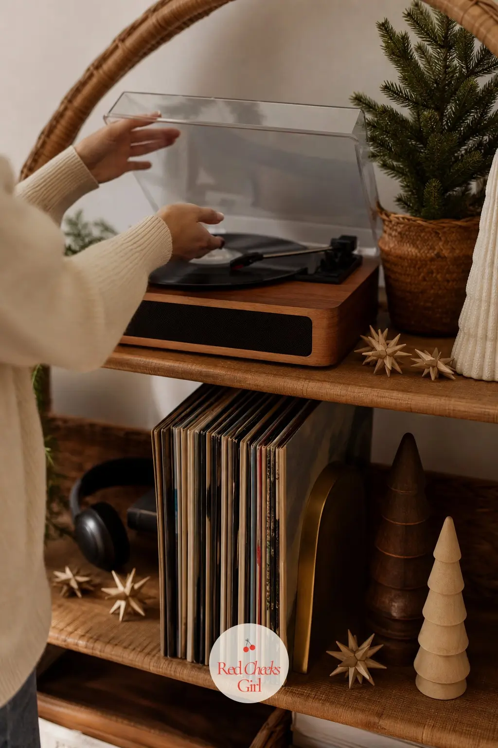 The Record Player Shelf — A small rattan stand holds the turntable, with a short run of records leaning against a brass bookend nearby. Boho christmas decor