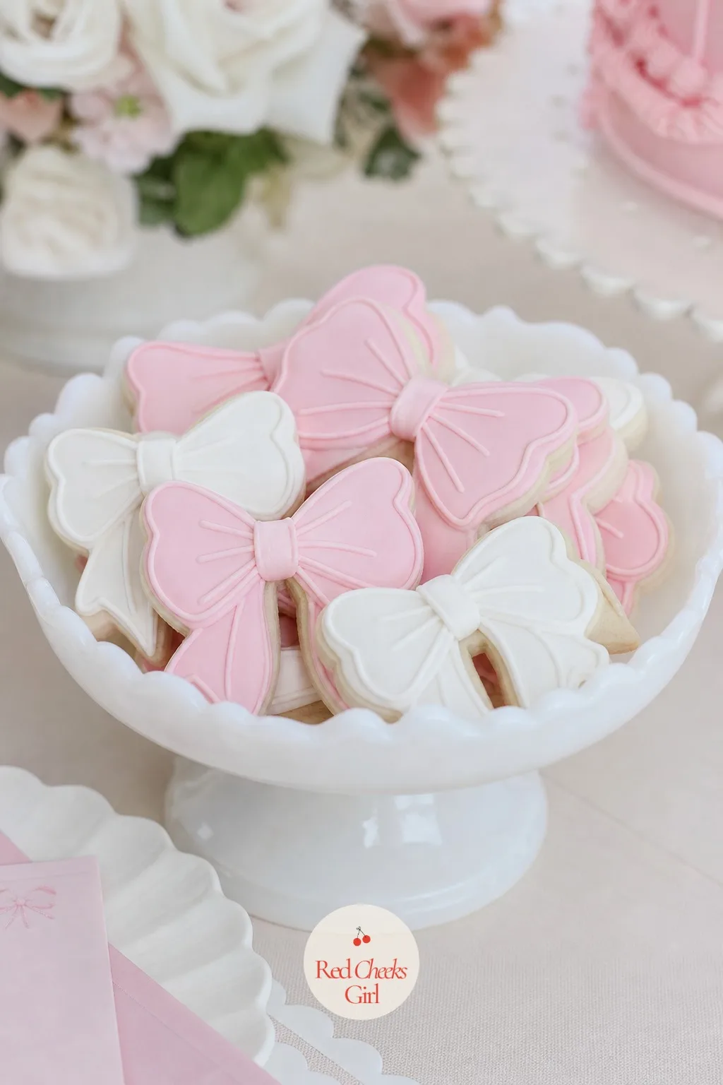 Bow Cookies in Milk Glass Dishes — Sugar cookies cut into a bow outline, iced in royal icing with piped ribbing lines across each loop, get piled into a