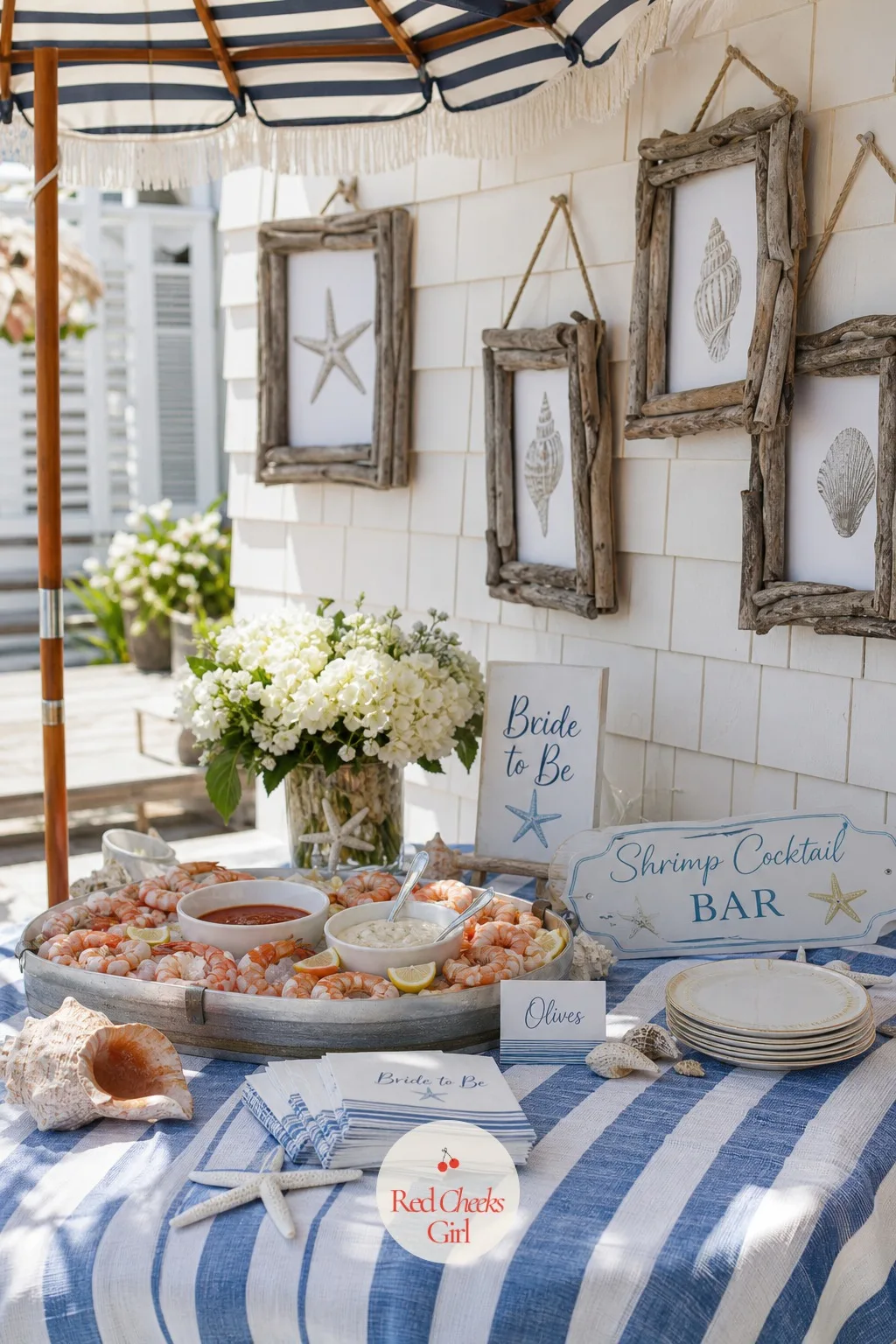 Beach Day — Blue and white stripes everywhere, real seashells gathered or bought by the bag, a small striped umbrella propped at the table's edge even if the