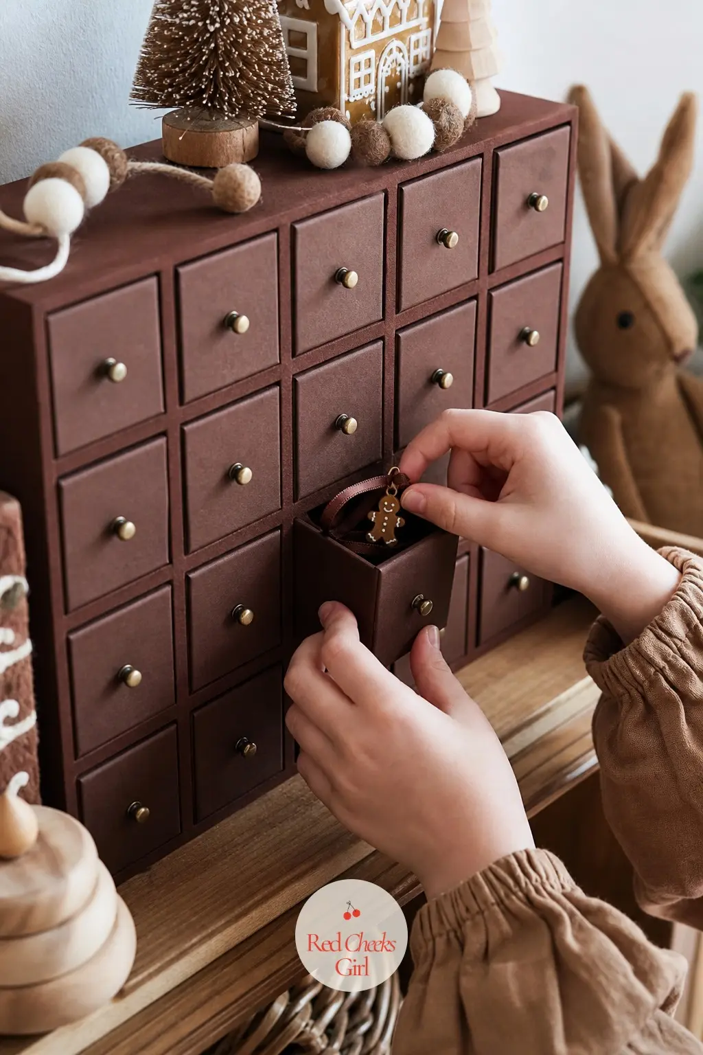 The Advent Drawers, Set with 24 Chocolate Velvet Pulls and a Gingerbread Charm Each — A corner just for the children: a cabinet of twenty-four small drawers