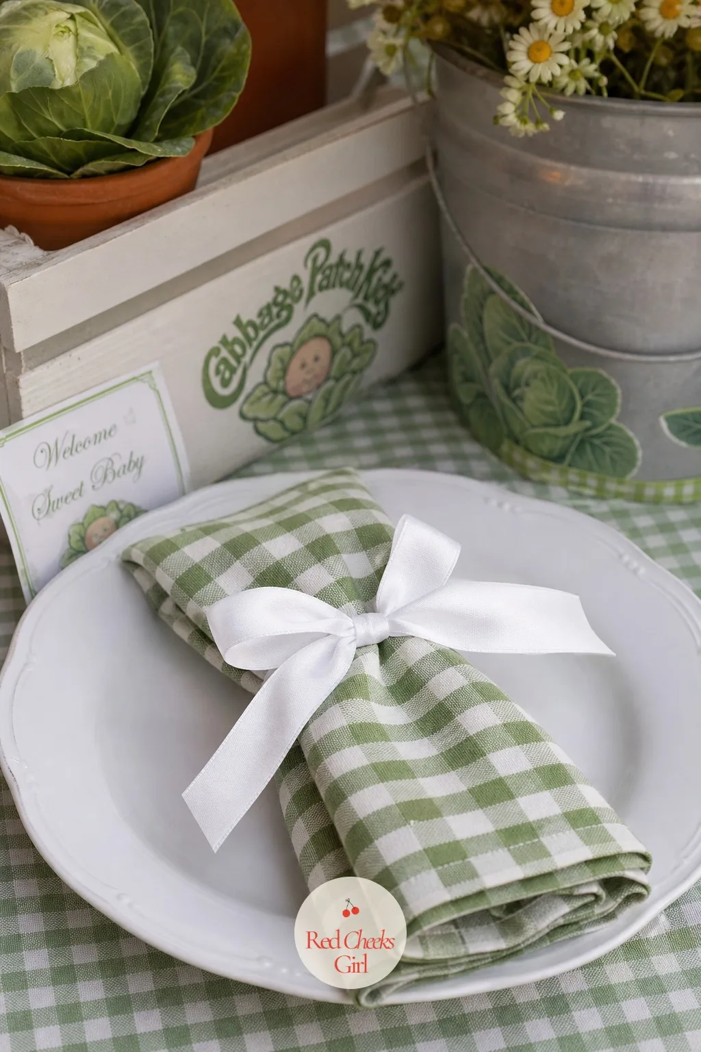 Gingham Napkin Tied With A Ribbon Bow — The tablecloth sets the mood, but a folded napkin at each place is what a guest actually touches first. Cabbage patch