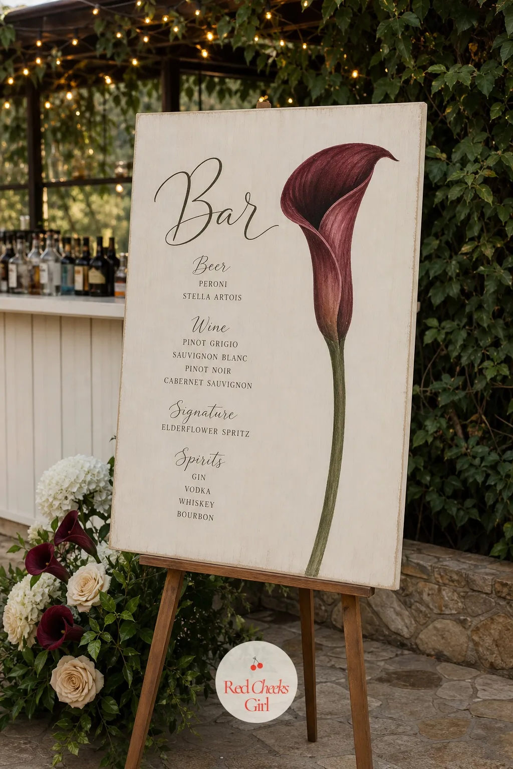 A Bar Sign Painted With a Calla Lily — Standing by the bar, a small sign carries a single large calla stem painted in burgundy down one side, with the drink