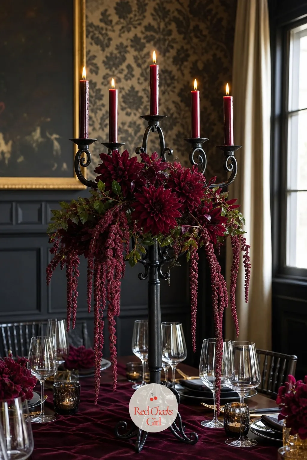 Black Candelabra with Burgundy Flowers — Black metal is the one finish that makes burgundy and deep plum look rich rather than muddy. Candelabra wedding