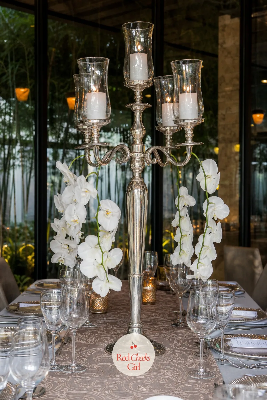 Candelabra with Hanging Orchids — Instead of climbing up, the flowers here hang down. Candelabra wedding centerpieces