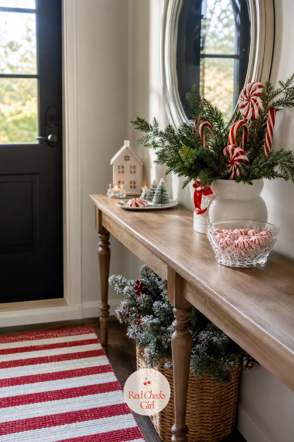 An Entryway That Smells Like Peppermint — A round mirror with a thin silver frame hangs above the spot where coats come off, reflecting the stripe back from