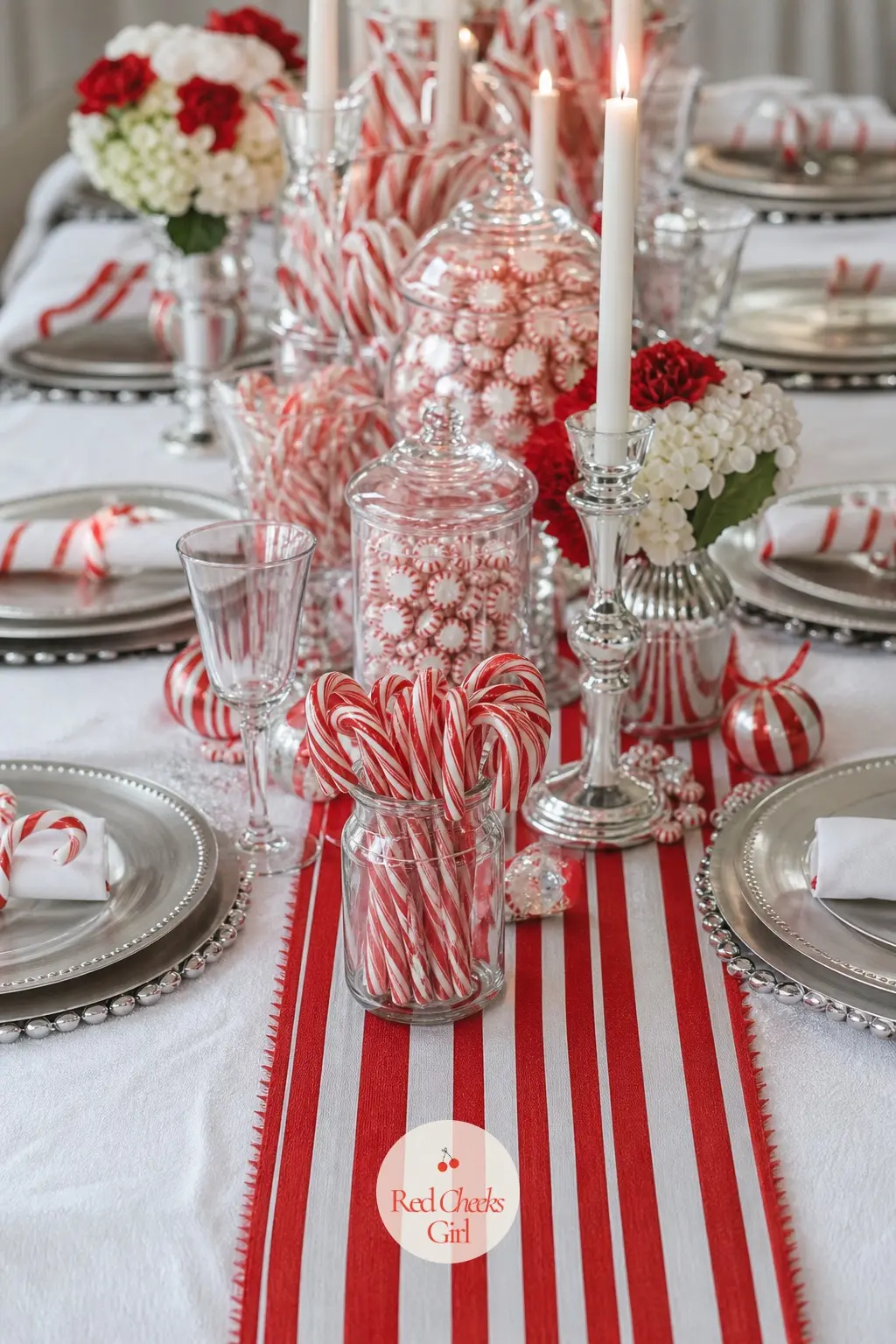 A Table Dressed In Peppermint Layers — A plain white tablecloth goes down first, then a red and white striped table runner laid straight down the centre rather