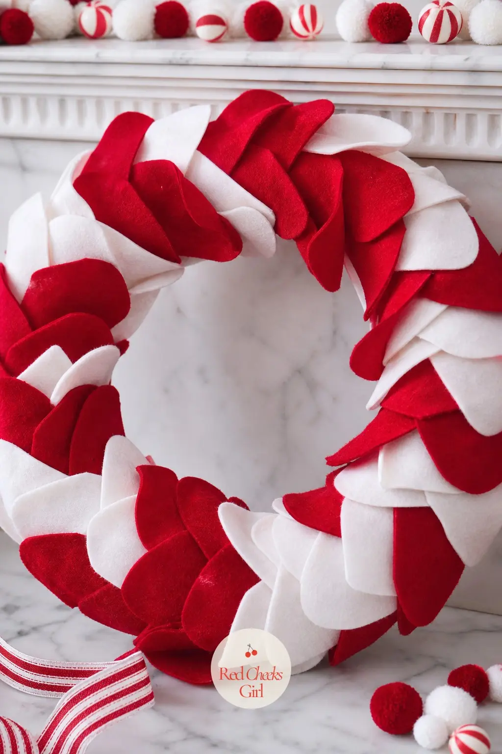 A Striped Wool Felt Wreath for the Mantel — Hand cut wool felt petals in red and white layer over a foam ring with raw, slightly fuzzy edges, giving a matte