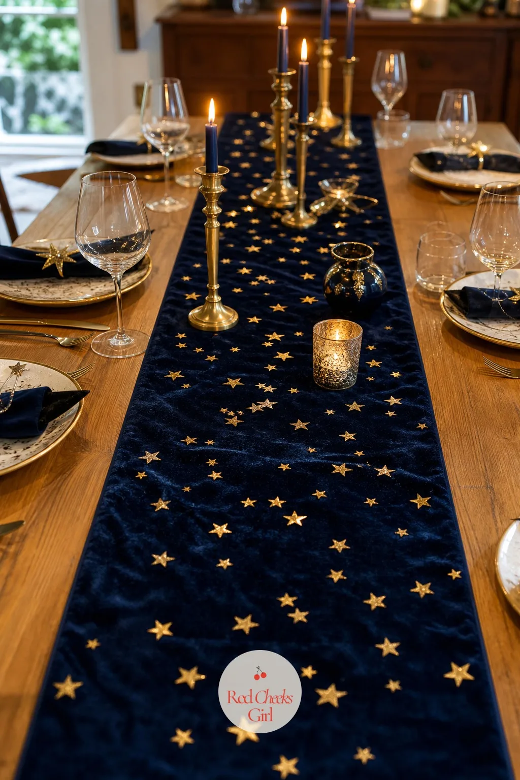 The Navy and Gold Table Runner with Star Confetti — A bare tablecloth under all that overhead lantern light looks flatter than it should, and this is the layer