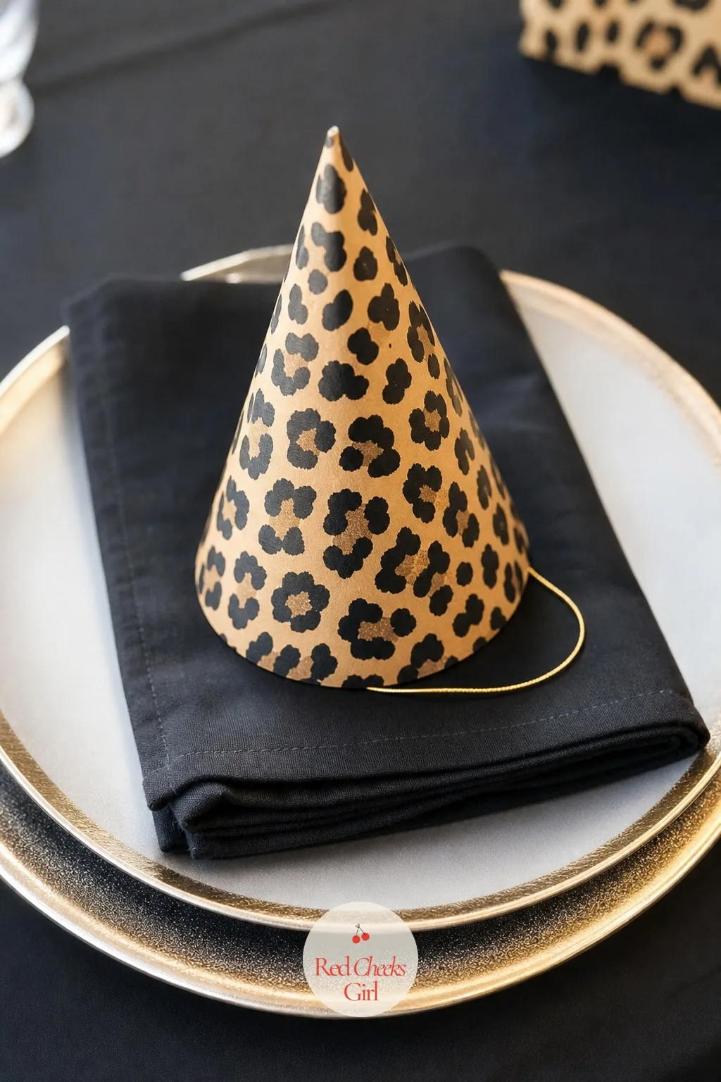 Leopard Print Party Hats at Each Place Setting — An empty place setting looks unfinished until something sits on top of the plate. Cheetah print birthday party