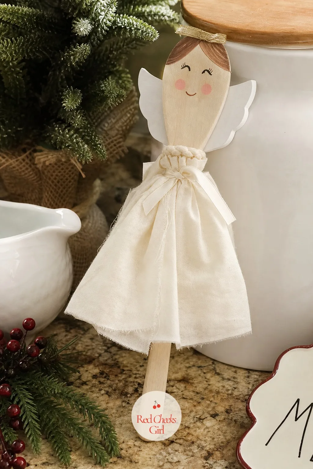 Hand Painted Wooden Spoon Angel — For the friend who hosts every year and never gets thanked properly for it, a wooden spoon painted into an angel face with a
