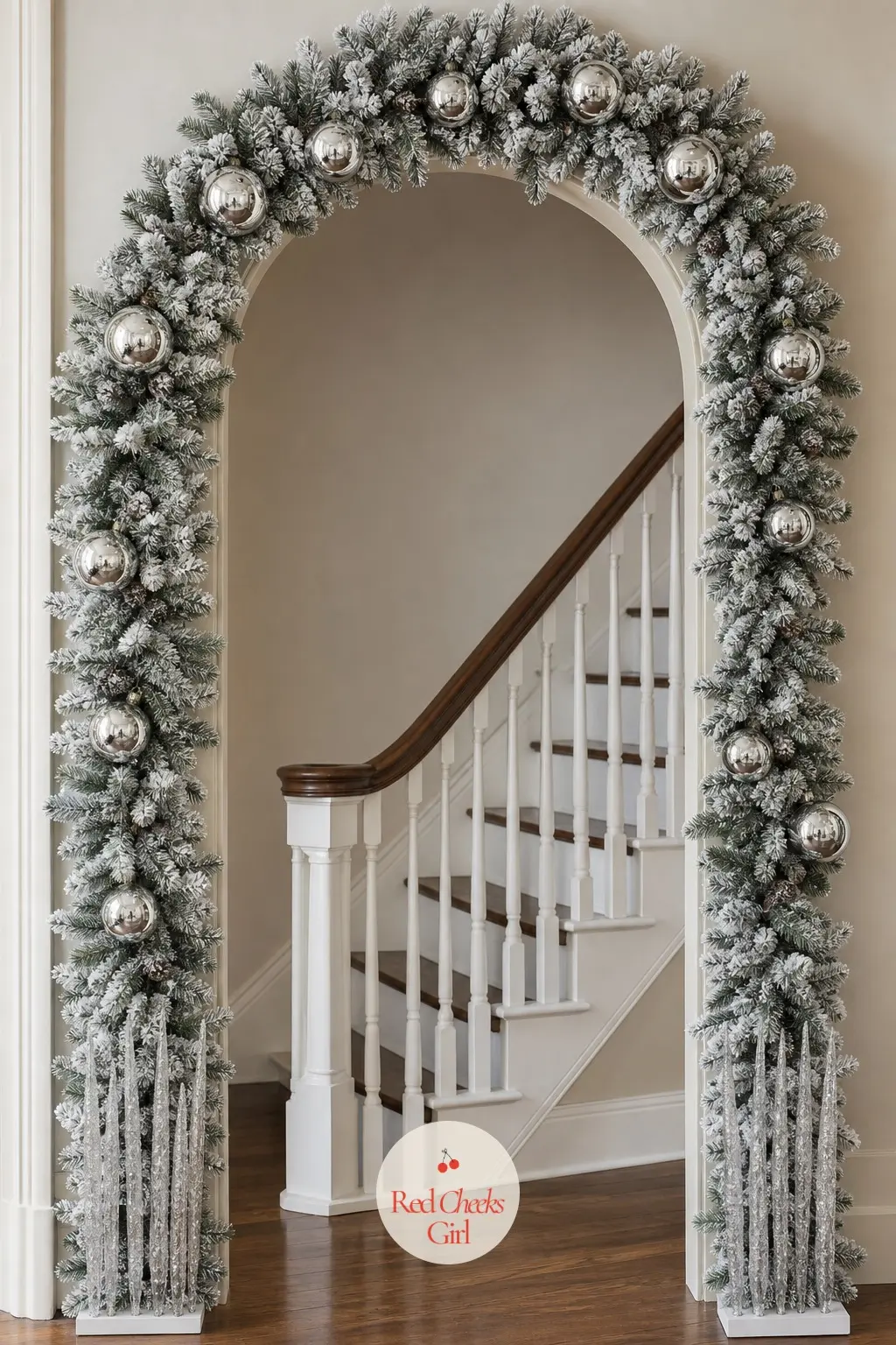 A Flocked Blue Spruce Archway with Silver Mercury Baubles and Icicle Picks — Flocked spruce already looks like it has caught the first snow of the season, so
